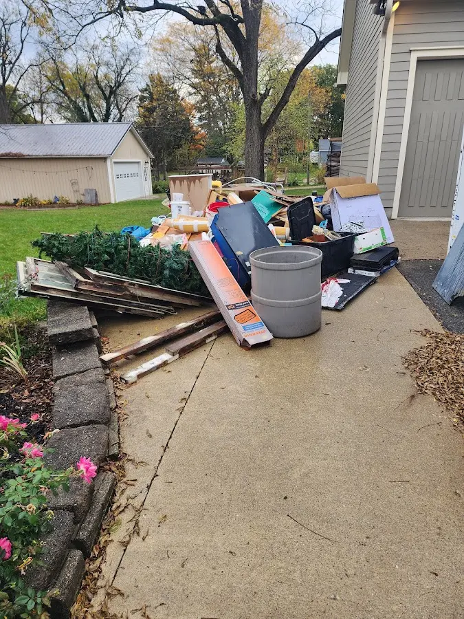 Dumpster being loaded with debris for Estate Cleanout Dumpster Rental in Shenandoah